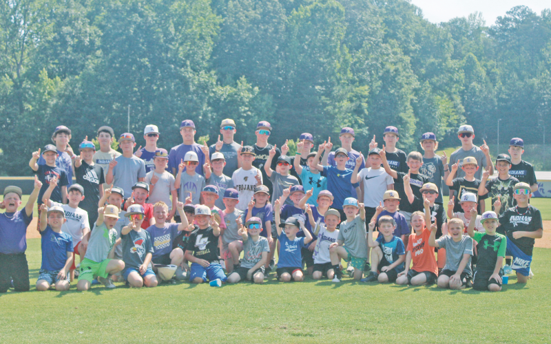 Baseball campers huddle for a photo before taking to the outfield to close out the summer fun.