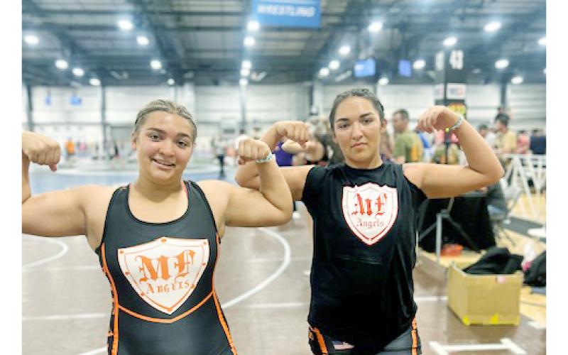 Natalie (left) and Mattie Mendoza showed their strength at the NHSCA National Duals meet.