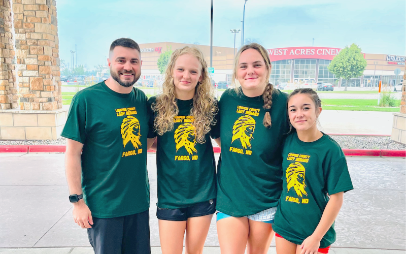 Pictured, from left, Lumpkin wrestling coach Scott DeGraff, Greta Garbuzovas, Faith Jones and Cadence Grulla gather outside the Fargo Dome in North Dakota.