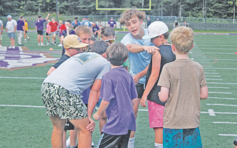 Micah Popko talks his team through a play during last week’s football camp.
