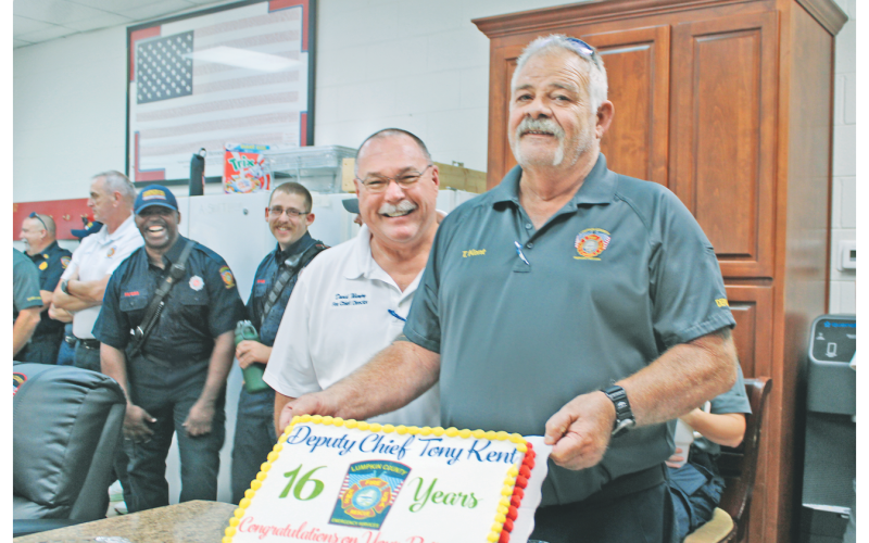 Deputy Chief Tony Kent celebrated 16 years with Lumpkin County Emergency Services during a retirement party Thursday afternoon at Fire Station #1. Below: Kent was gifted a commemorative axe by his peers.