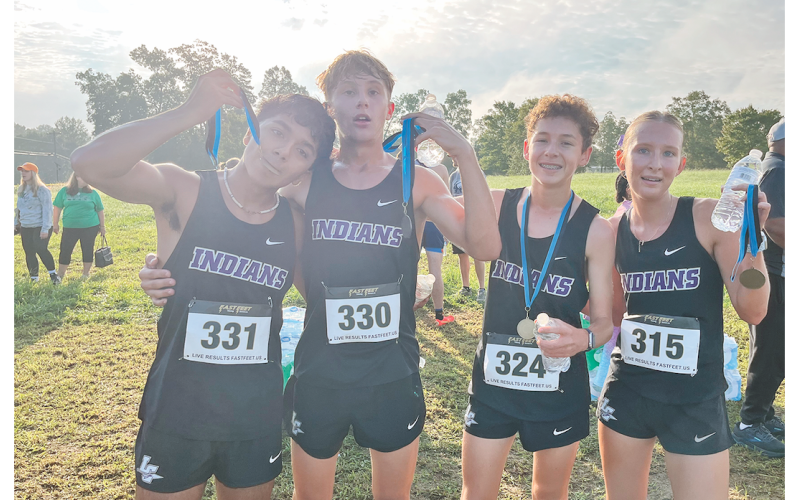 Pictured (from left): Paulo Ramirez, Nickson McGillivray, Bowen Aiken and Ari Cook celebrate the cross country team’s recent race accomplishments.