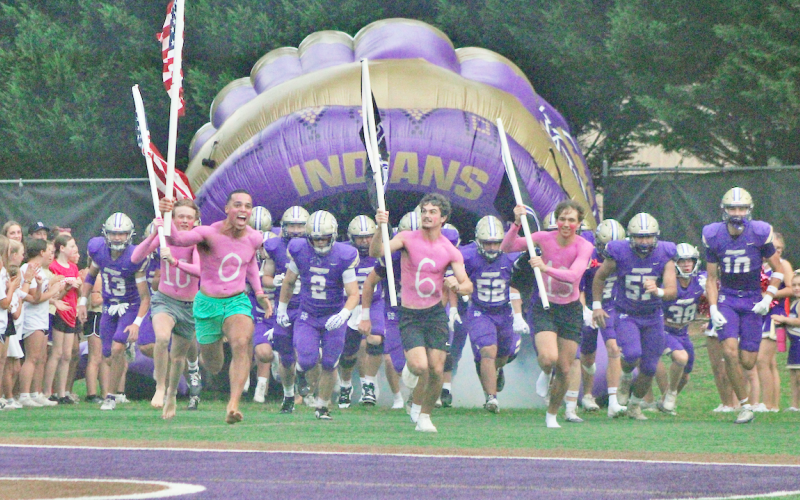 The Indians storm the field ahead of their showdown against Cherokee Bluff in the season opener.
