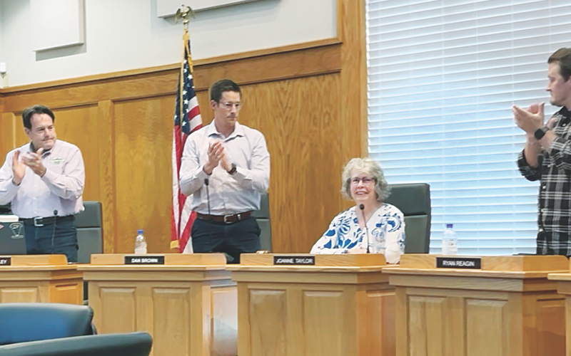 Mayor JoAnne Taylor receives an appreciative standing ovation from City Council members and attendees at last Monday's meeting.
