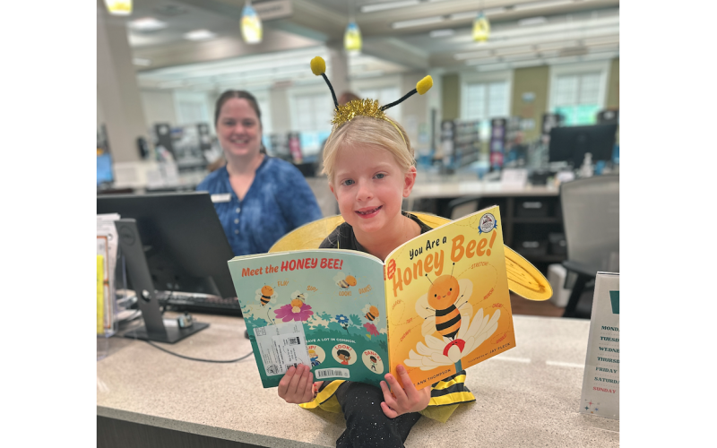 A local winged celebrity buzzed by the Lumpkin County Library recently to help spread the news about the upcoming Lumpkin Literacy Adult Spelling Bee &amp; Variety Show which is taking place October 7 at 7 p.m. in the University of North Georgia’s Hoag Auditorium. Admission is free to the donation-only event. Pictured, Eleanora Sizemore, the actual Spelling Bee, will be making appearances in The Nugget in the weeks leading up to the big show as she visits key contributors to the cause of local literacy.