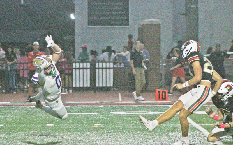 Wolf Harbin attempts to block a field goal against the Spartans.