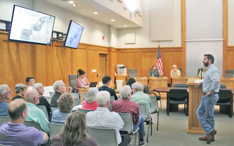 Warren Welch, Project Manager for The Overlook development, answers questions from the public about his amended PUD zoning proposal during a packed meeting of the Dahlonega Planning Commission.