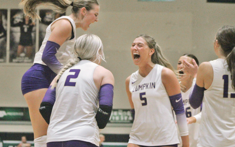 Layla Melius, Averie Simmons and Maddie Lee celebrate a Lumpkin score together.