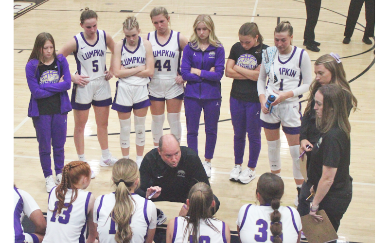 Lumpkin County Girls Basketball head coach Brian Richerson talks strategy with his team.