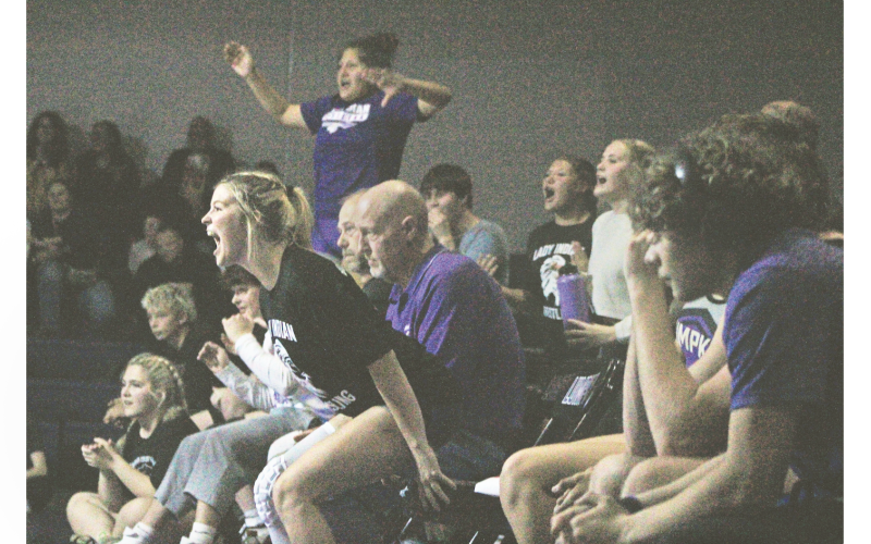 Gaby Luper and her Lumpkin teammates cheer on the squad from the sideline.
