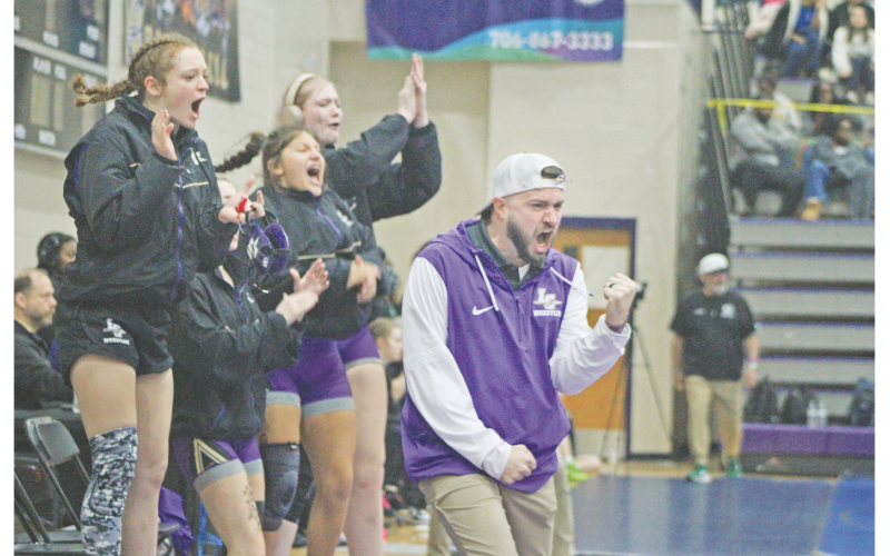 Scott Degraff and the Lumpkin County Girls Wrestling team celebrate a big win at last year’s State Championships.
