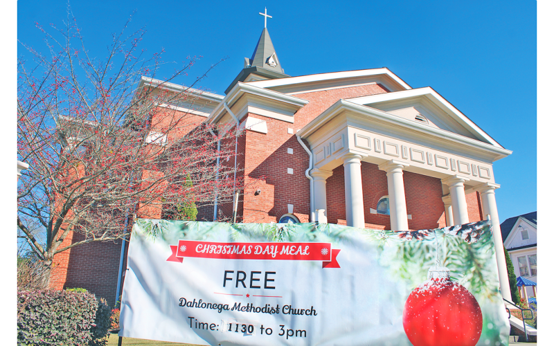 A banner hanging in front of Dahlonega Methodist Church on South Park Street advertises their upcoming free Christmas Day Meal for the community, which will be served from 11:30 a.m. to 3 p.m. inside the Fellowship Hall.