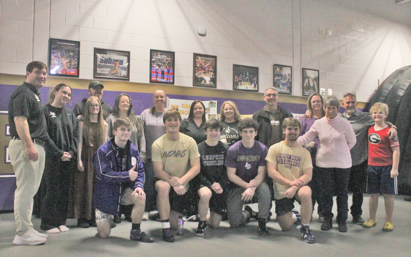Lumpkin County wrestling seniors gather for a photo with their family and coaches following the match.