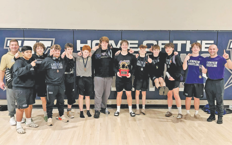 The Lumpkin County boys wrestling team celebrates its first place win at the Spartan Slam.
