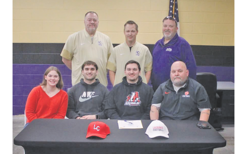Jacob Baloga celebrates his college commitment alongside his family and coaches.