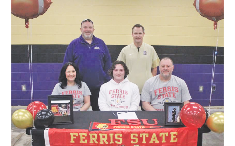 Nolan Matthews signs his college commitment alongside his family and coaches.