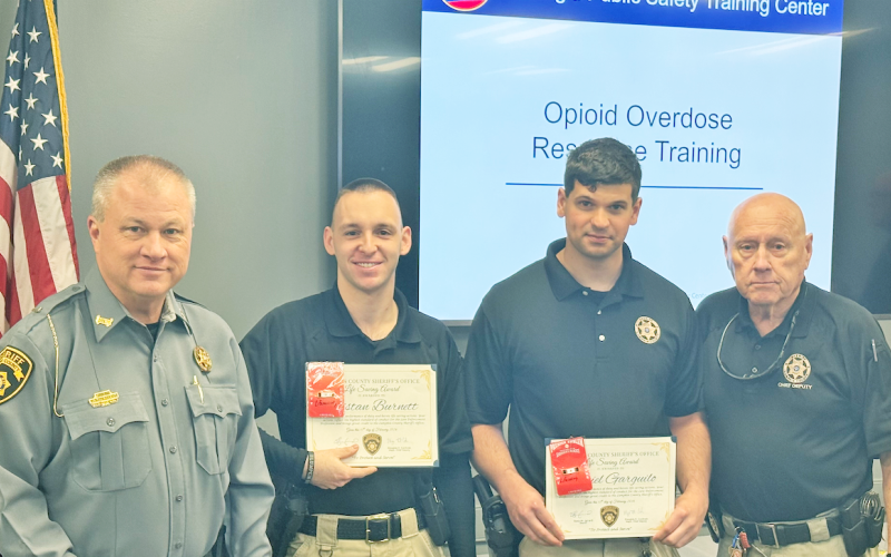 Sheriff Stacy Jarrard, far left, and Major Doug Cochran, far right, present the LCSO Life Saving Award to Sgt. Tristan Burnett, left, and Deputy Daniel Garguilo during a special meeting last month.