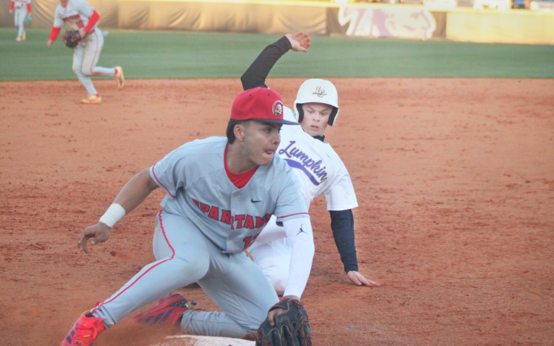 Logan Hamrick slides into third as a GAC defender blocks the bag.