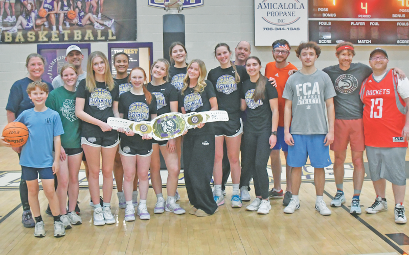The Lady Indians and Team Nugget gather for a postgame photo, celebrating what was a very fun night on the Lumpkin County High School basketball court.