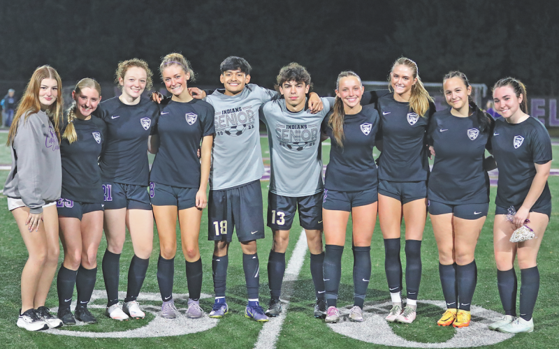 Soccer team seniors share a moment together on the 50-yard line during Lumpkin County Senior Night.