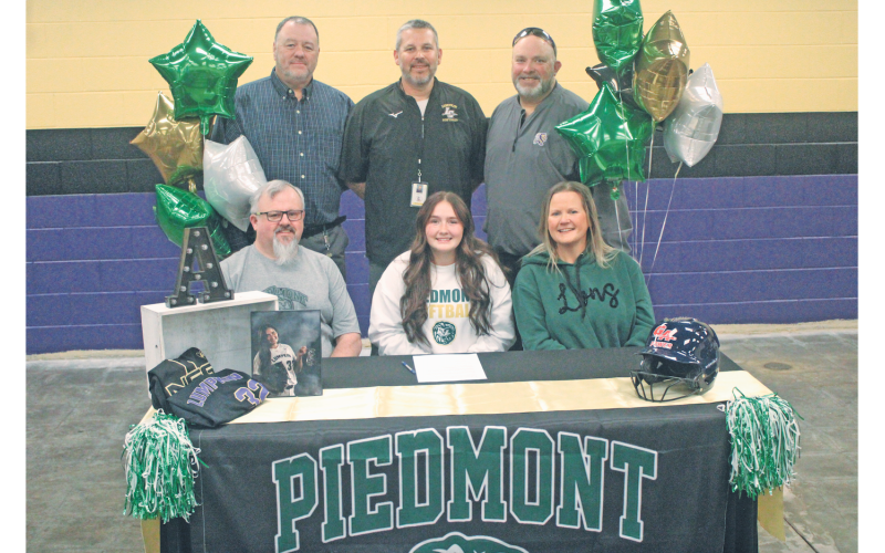 Ava Estes celebrates her college commitment with her coaches and family.