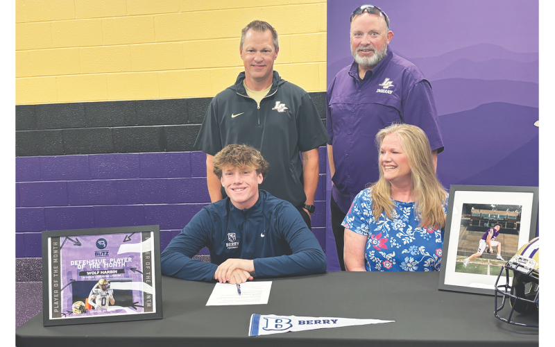 Lumpkin senior Wolf Harbin celebrates his college commitment with his mom and coaches.