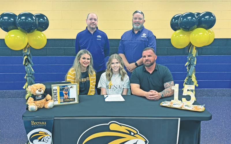 Lumpkin basketball player Alayna Lindley celebrates her college signing with her coaches and family.