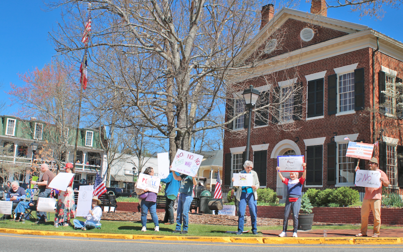 A crowd of local protestors gathered on the Square last Saturday on the lawn next to the Gold Museum.