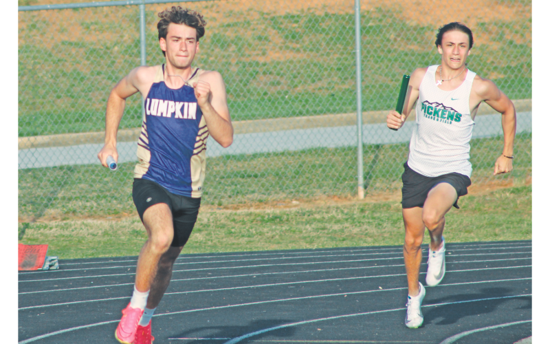 Jeb Jackson races his way to the hand-off in the boy’s relay race at White County.