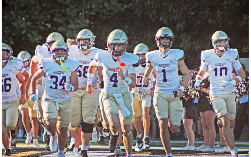 Starting quarterback Kolson Howell leads the Indians onto the field during their Spring Game at East Hall.
