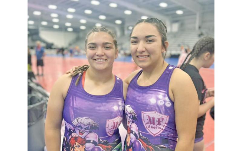 Lumpkin County wrestlers Natalie (left) and Mathiel Mendoza share a fun moment ahead of one of their matches.