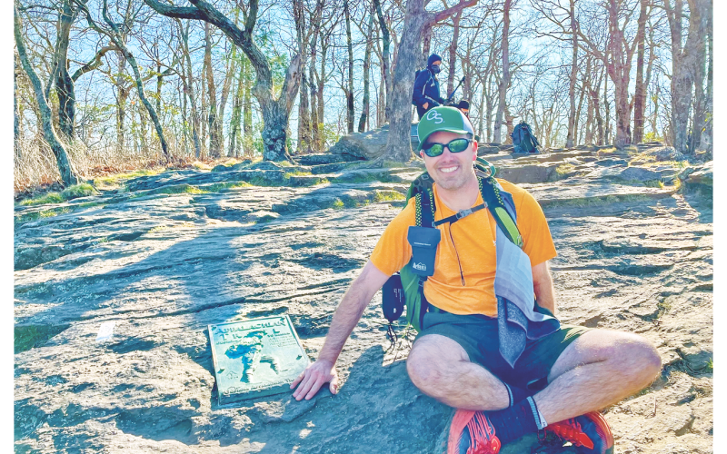 Kevin “Chop Chop” Remillard touches a plaque on Springer Mountain, the Southern terminus of the Appalachian Trail. Remillard completed a successful six month thru-hike of the AT in 2022 as part of a personal strategy to address anxiety and depression.