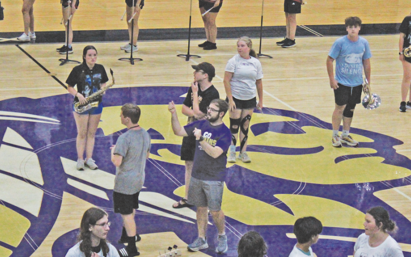 Band Director Corey Jackson talks his students through the routine before the recent early preview of this year’s new band.