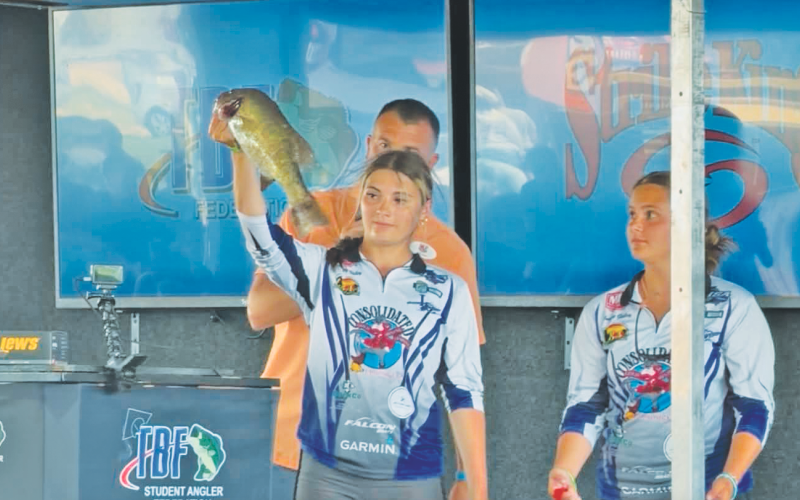 Lyndsey Gailey shows off her catch, alongside her sister Audrey, at the World Championships.