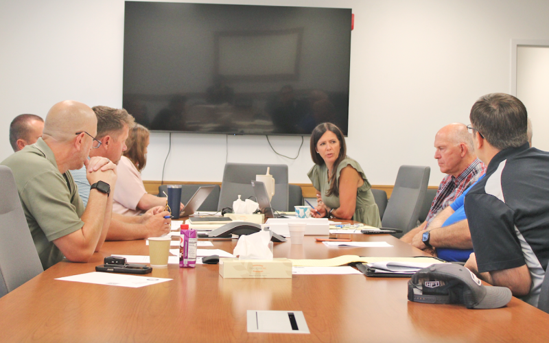 Lumpkin County Finance Directory Abby Branan (center) speaks to the Board of Commissioners during an August 7 special called meeting. Ultimately, the Board settled on a scaled-back 2027 budget of $34,674,700 with a full rollback of the local millage rate used to calculate real estate property taxes.