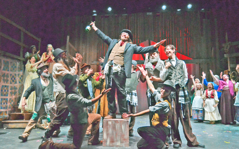 The sizable singing, dancing, music-making cast of Fiddler on the Roof will fill the stage at The Holly Theater over the next two weekends. (Photo by Sean Newman)