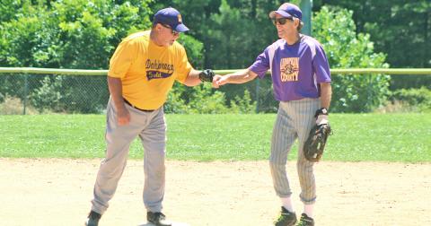 Miners second baseman Larry “Motoring” Morton congratulates the Dahlonega Gold’s Mike “Walloping” Williams after Williams belted a double in game two of a non-league doubleheader last week.