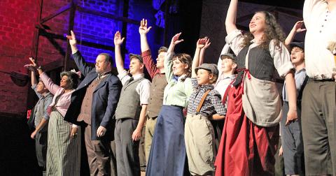The cast of Newsies at The Holly takes a bow following its final rehearsal on Thursday, July 25. The show is filled with high energy dances and songs and keeps the audience engaged throughout, often taking the action off the stage and into the crowd. The musical is scheduled to run the next two weekends (August 2-4 and 9-11).