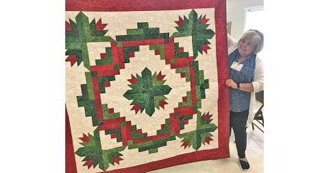 Lynda Duke stands beside the Christmas quilt that will be raffled off Friday, July 26 at The Common Thread. The raffle is part of the shop’s Christmas in July Quilt Show, free and open to the public. Raffle tickets are $5 and proceeds go to support the Dahlonega Valor Quilters, who provide quilts to Lumpkin County’s veterans as a thank you for their service.