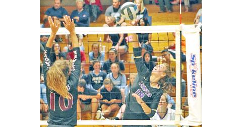 Lady Indians player Victoria Crotzer gets her team a point with a powerful hit at the net.