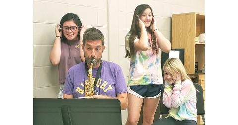 The sounds of the sax were a little less melodic when Nugget sportswriter Greg Finan, Jr. took part in the Fast Start Clinic Band Camp at LCMS last Saturday. Pictured (left to right): Instructors Jenna Crawford and Chasen Wood and camp participant Bethany Dix try to avoid the noise produced by Nugget sportswriter Greg Finan, Jr. playing the alto sax.
