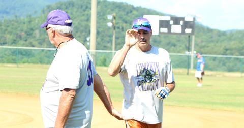 Jimmy “Four Quarters” Dollar gives “Hammering” Harvey Schmedlapp a high-five after Schmedlapp belted a solo home run over the centerfield fence during the Miners’ league doubleheader against the Lake Keowee Kings.