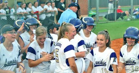 Evee Dornhecker is mobbed by her teammates after belting a game-tying solo shot to left field during the Lady Indians' game versus East Hall.