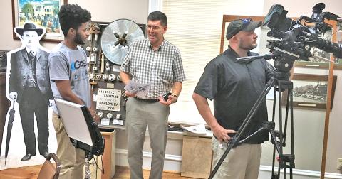 Associate producer Michael Harris (left) talks with Lumpkin County Historical Society president Chris Worick as videographer Wesley Nichols films segments for an upcoming episode of the GPB show Hometown Georgia to air on Oct. 31.