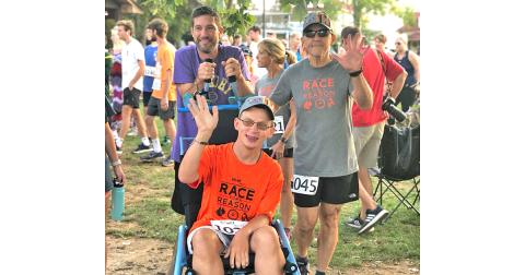Nugget sportswriter Greg Finan, Jr. gets ready to head to the starting line with his Race for a Reason team of Logan (middle) and Hugo (right). 