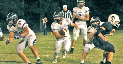 LCHS running back Tanner Barber utilizes some blocking to pick up some hard fought for yards in the Indians’ 31-0 loss to Jackson County.