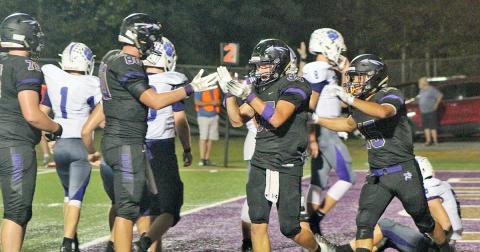 Indians running back BoJack Dowdy applauds his teammates after scoring his third touchdown in Lumpkin’s victory over the Gilmer County Bobcats last Friday. Dowdy rushed for 167 yards and three touchdowns in the game.