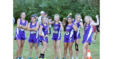The Lady Indians cross country team flexes its muscles before earning a fourth place team finish at the Region 7-AAA championship to advance to the GHSA State Cross Country Championship Meet last week.