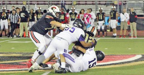 Joseph Allison and Trey Wilkes converge on GAC’s quarterback for a sack during the Indians’ loss to the Spartans.