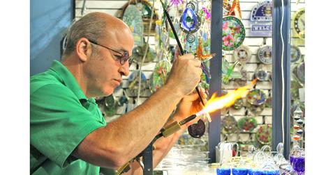 The Glassblowing Shop owner Chris Kennedy, a fourth generation glassblower, works effortlessly to combine two glass rods together for an order of icicle Christmas ornaments. This story is one of many regional features in the new edition of The Mountain Traveler magazine.